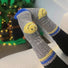 Light grey and blue striped socks with a hidden smiley on the heel, perfect for everyday dressing.