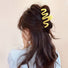 Model wearing Macaron Wave Hair Claw in yellow, easy for workdays and special occasions.