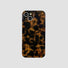 Maillard Amber silicone iPhone case with a tortoiseshell pattern. Classic dark academia aesthetic.
