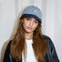 Woman wearing a blue and white Mash Up Stripe C Cap, a breathable cotton baseball cap for active outdoor styling.
