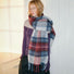 Model wearing Midnight Blaze Plaid Scarf, a long wool blend scarf with red, blue, and white plaid, ideal for daily.