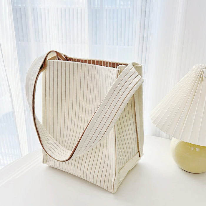 Cream polyester woven tote bag with vertical texture, milk carton design, and brown striped lining.