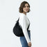 Model styling the black duvet crescent bag with a streetwear outfit.