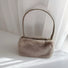 Angled view of Mini Shearling Baguette Bag in khaki, great for everyday carry and travel.
