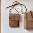 Flat lay of Minimalist Rigid Leather Bag in khaki, ideal for errands and gifting.