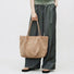 Modern Muse Suede Tote in Khaki - Model shot showing minimalist style - Premium laptop bag for women.