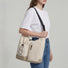 Model carrying the khaki multi-pocket bag on shoulder, functional daily lifestyle view.