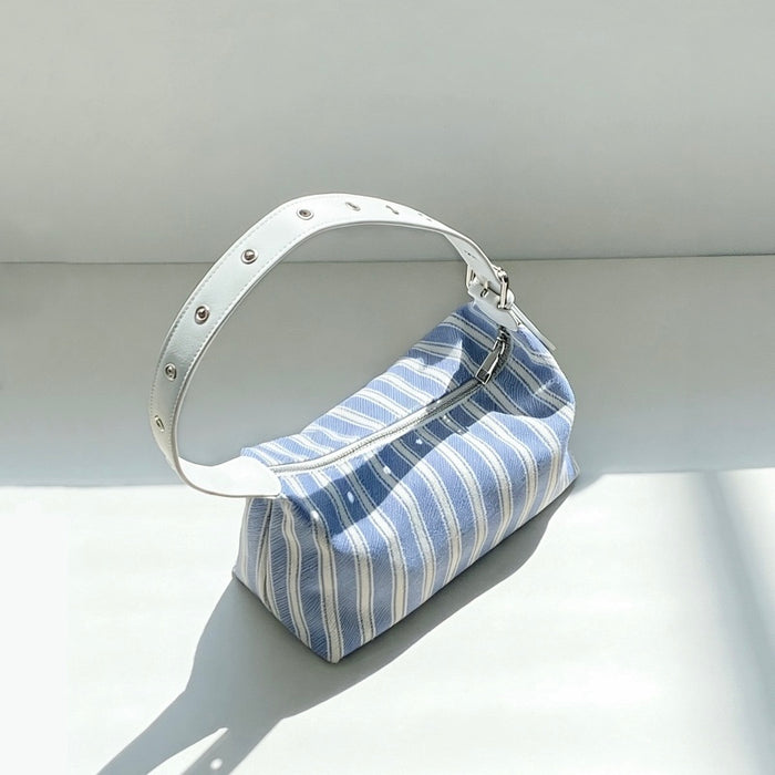 Blue and white nautical striped canvas bag featuring a white studded leather strap.