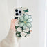 Model holding Oil Painting Rose Case. Elegant vintage floral art on a durable protective silicone body.