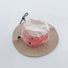 Detailed view of the light khaki and rose pink ultralight hat with its adjustable cord.