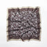 Close-up of brown paisley scarf highlighting refined edge detailing and artistic craftsmanship.