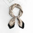 Light khaki paisley scarf folded neatly ideal for professional travel and business meeting accessorizing.