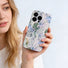 A model holding the nature-inspired phone case, highlighting its soft colors and slim profile.