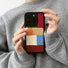 Model holding Pixel Patch Plush Case. Soft-touch pixelated textile on a protective silicone frame.