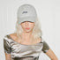 Model wearing beige Plaid Chill Cap, showcasing traditional plaid motifs on a durable and structured frame.