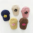 Display showing five plus flower corduroy cap in  navy blue, beige, pink, brown and mustard.