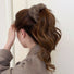Model wearing Plush Scrunchie in brown, ideal for quick updos and ponytails.