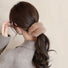 Model wearing Plush Scrunchie in tan, easy for workdays and special occasions.