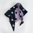 Flatlay view of purple and black contrast polka dot knit scarf.