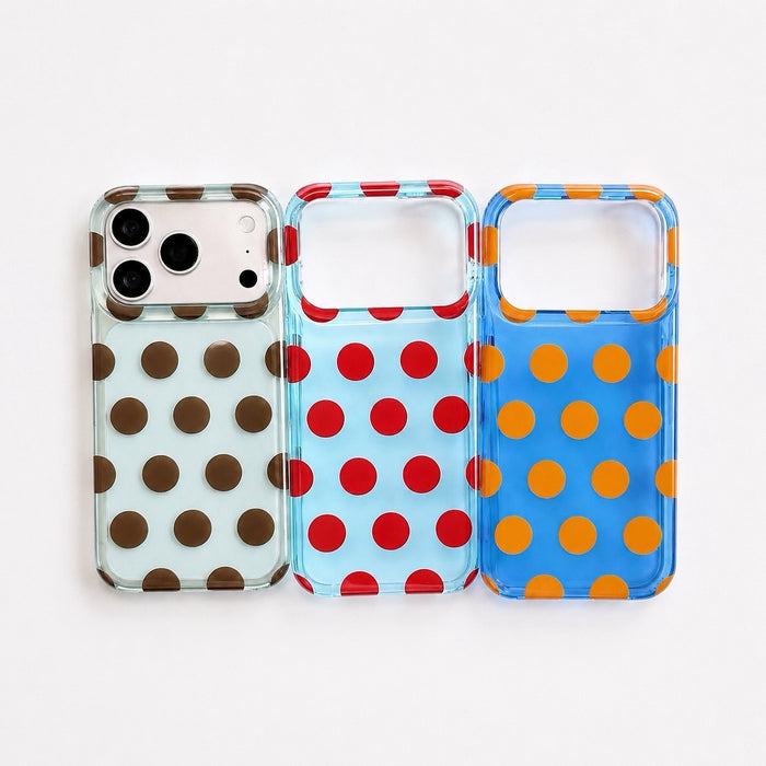 Flat lay of mint/brown dot, light blue/red dot, and blue/orange dot silicone iPhone cases displaying camera cutout alignment.