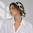 Model styling soft black polka dot silk scarf as a hairband.