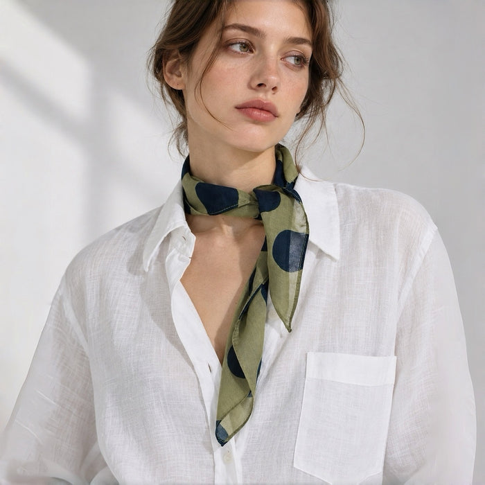 Model wearing soft green polka dot silk scarf as a neckerchief.