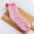 Folded view of Pompom Cupcake Socks in pink, great for daily wear and lounging.