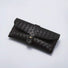 Flat lay of black Portable Woven Leather Glasses Case with buckle closure.