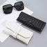 Front view of Black and white woven PU leather glasses cases with gold button closures, beside black sunglasses.