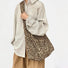 Primal Leopard canvas slouchy bag with adjustable strap, worn crossbody.