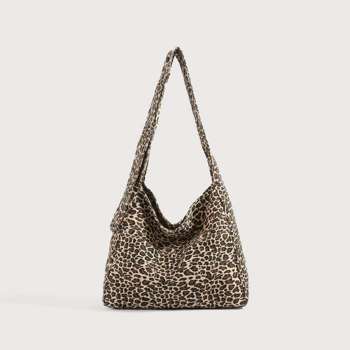 Primal Leopard canvas slouchy bag with adjustable strap and outer slip pocket.