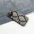 Realistic python skin motif on a durable silicone iPhone case. High-fashion animal print accessory.