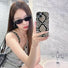Model holding Printed Python Case. High-fashion snake motif on a flexible and resilient silicone frame.