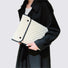 Model carrying a white cotton  laptop sleeves, easy for commuting and weekends.