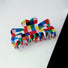 Flat lay of Rainbow Plaid Claw , ideal for quick updos and ponytails.
