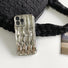 Detailed view of the metallic silver wave phone case.