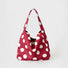 Red suede bag with white polka dots, highlighting the slouchy hobo silhouette.
