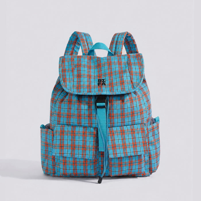 Studio flat lay of the blue and orange retro colorblock plaid nylon backpack showing front buckle flap pockets.