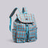 Three-quarter studio view of the blue and orange plaid nylon backpack displaying side pockets.