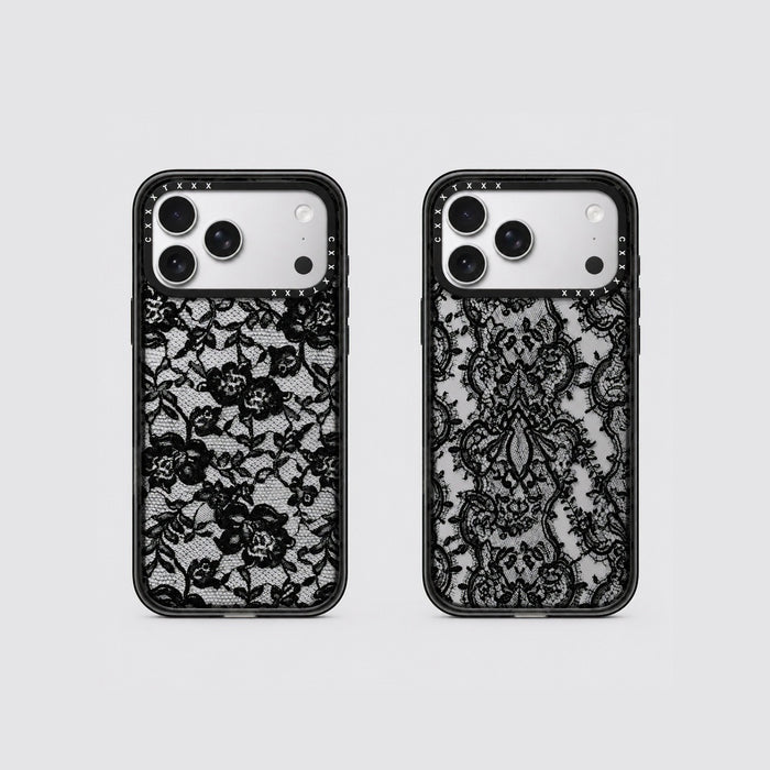 Flatlay view of two retro lace phone cases showing scroll lace and floral lace patterns on clear back panels.