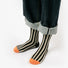 Model wearing a pair of orange striped cotton socks, easy for travel days and daily comfort.