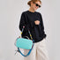 Model carrying the cyan nylon utility bag on her arm.