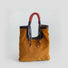 Front view of a dual-textured tote in soft corduroy with artisan braided rope handles.