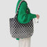Model carrying a black Ripple Texture Tote Bag on shoulder, ideal for city walks and gifting.