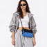 Model styling the blue Rope Play bag as a crossbody.