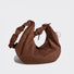 Angled view of Brown vegan suede hobo bag with a slouchy crescent shape and adjustable ruched strap
