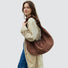 Model carrying a brown Ruched Strap Suede Hobo Bag on the shoulder , ideal for city walks and gifting.