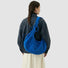 Model carrying a blue bag on the shoulder, ideal for city walks and gifting.