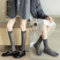Two models wearing grey split-toe socks with silver thread stripe, ideal for everyday outfits and sneakers.