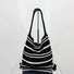 Angled view of Simple Striped Knitted Bag in black and white, great for everyday carry and travel.
